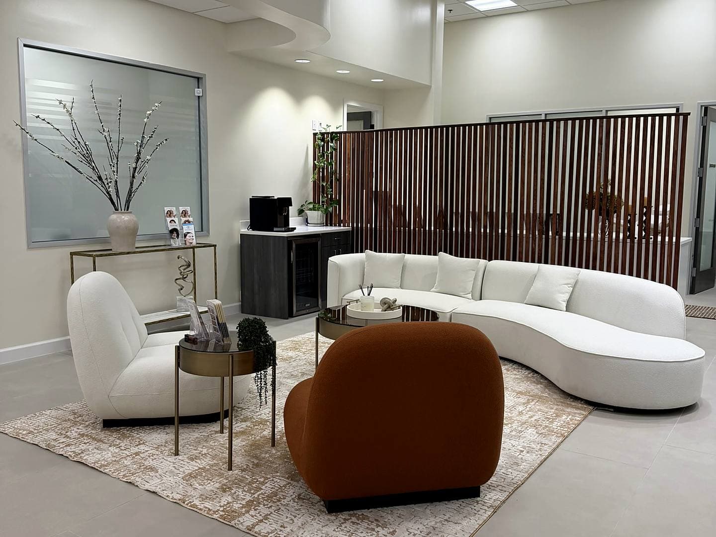 Relaxation lounge with cream armchairs at The Body Bar MD in Ellicott City
