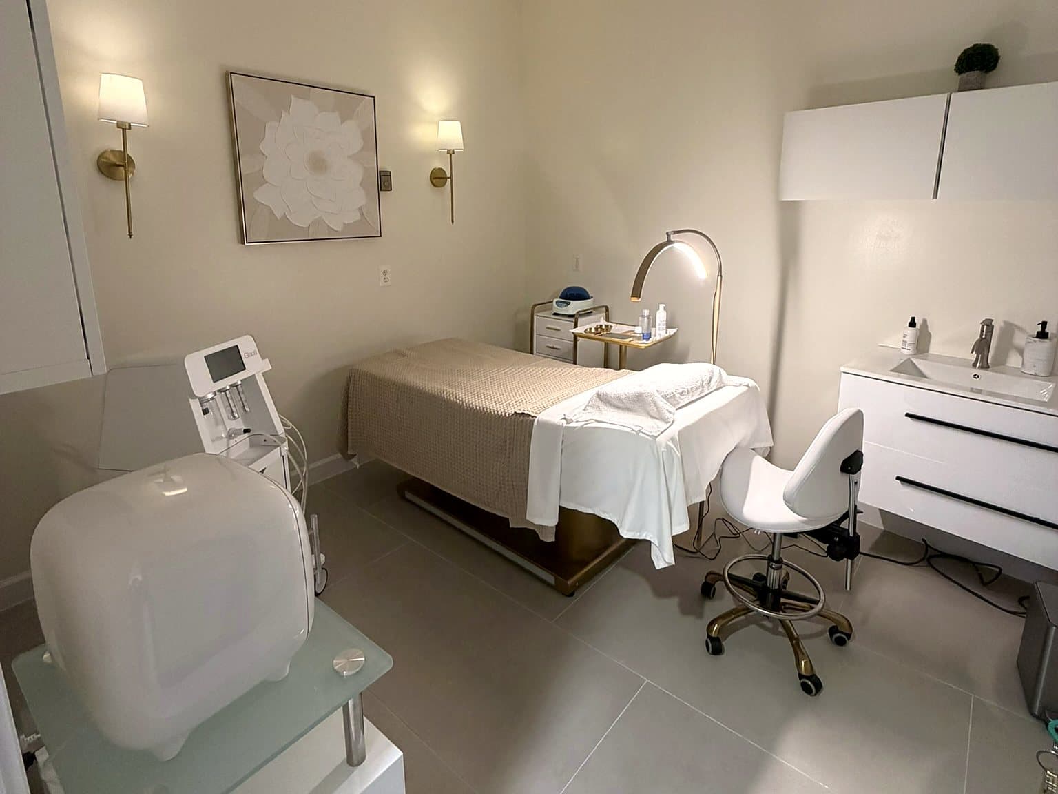 Private treatment room with a gold-trimmed bed at The Body Bar MD